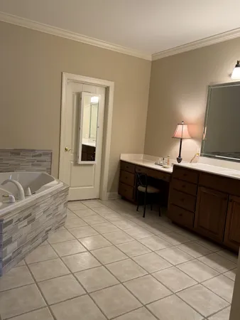 a spacious bedroom with a bed and a desk