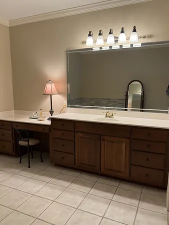 a room with a chair and cabinets