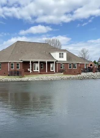 a front view of a house with lake view and a large window