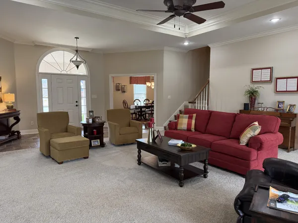a living room with furniture and a chandelier