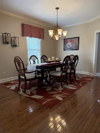 a living room filled with furniture and a chandelier