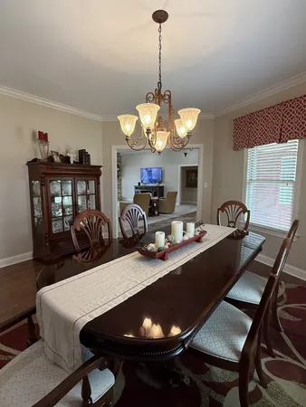 a view of a dining room with furniture and chandelier