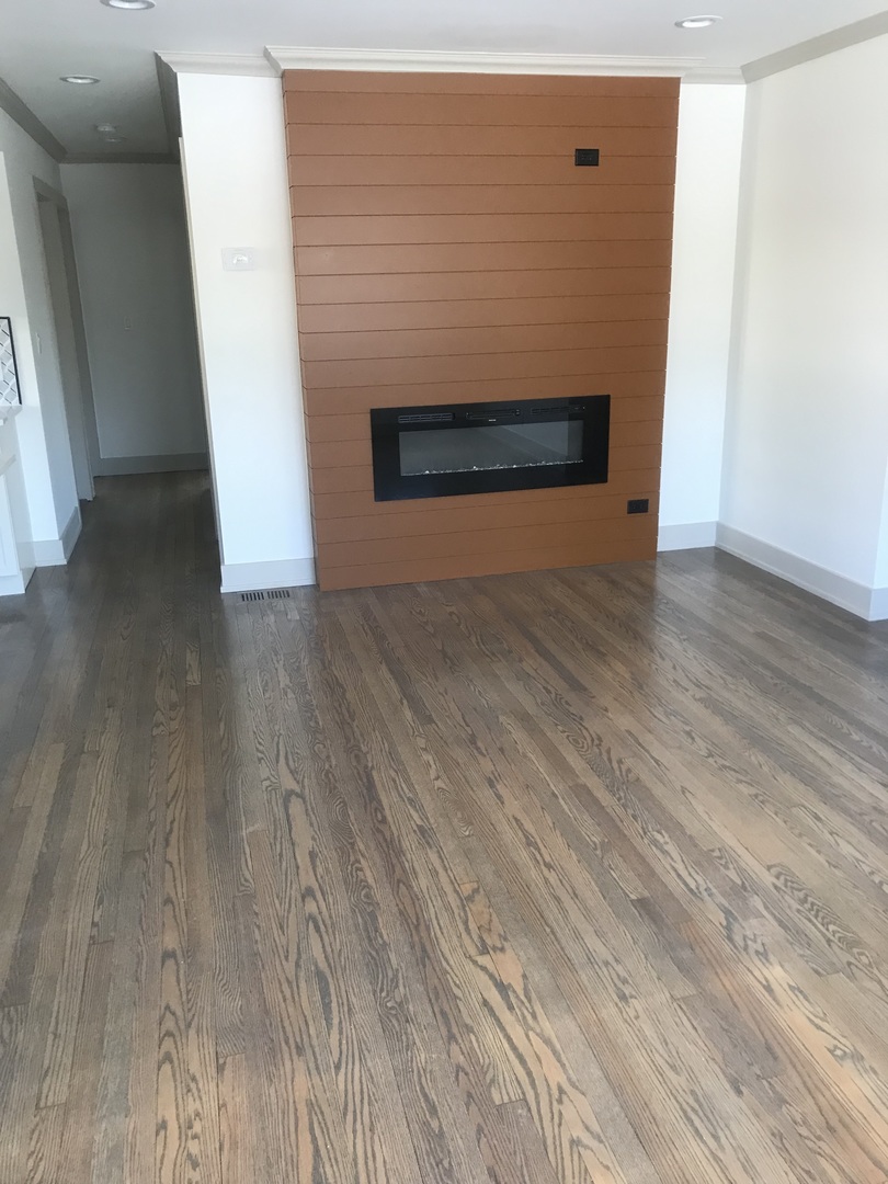 149 Rice Avenue Bellwood, IL 60104 - Photo 7 of 13 a view of an empty room and wooden floor