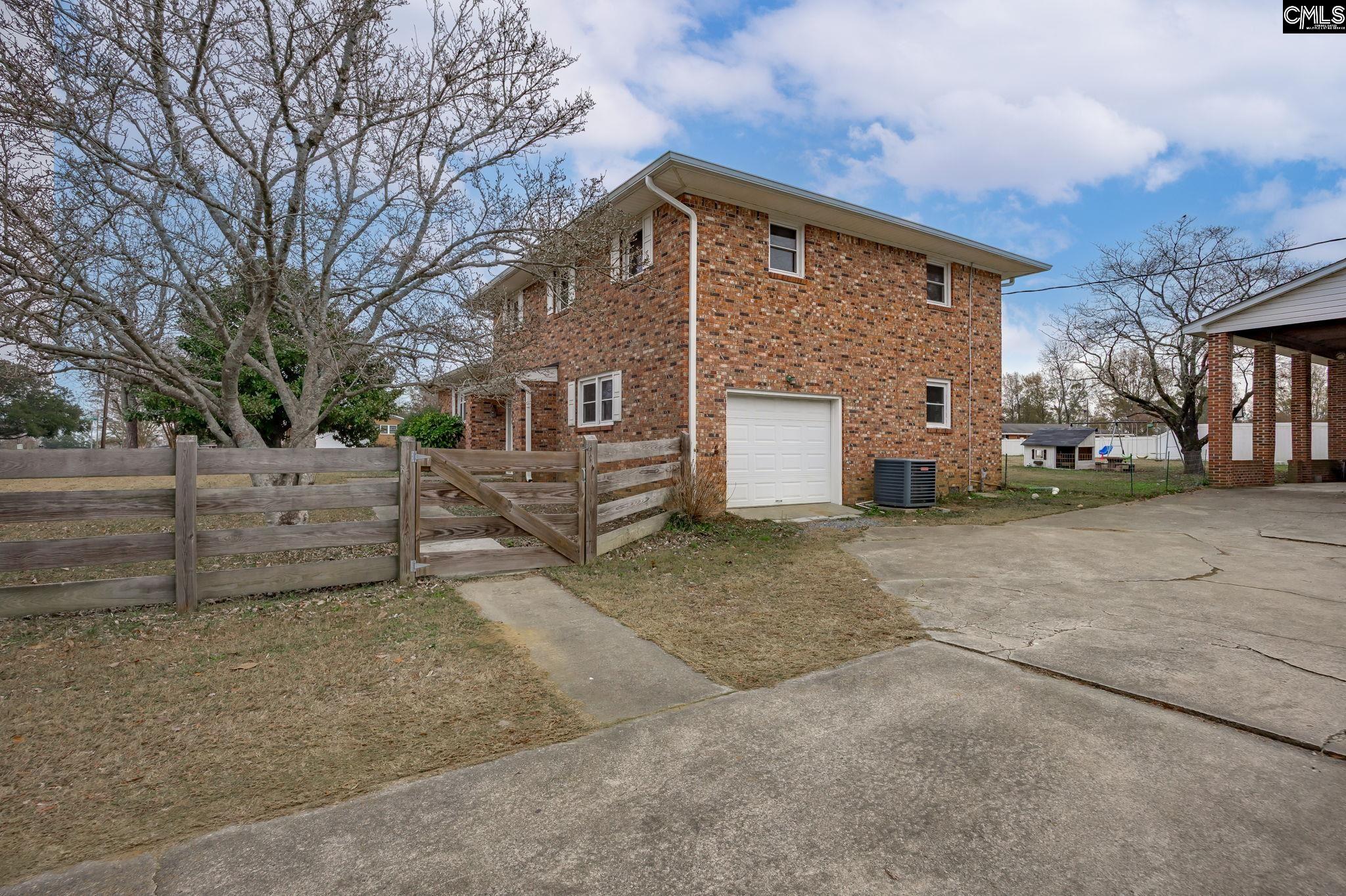 560 Edisto Street Batesburg, SC 29006 - Photo 45 of 49 a front view of a house with a yard and garage