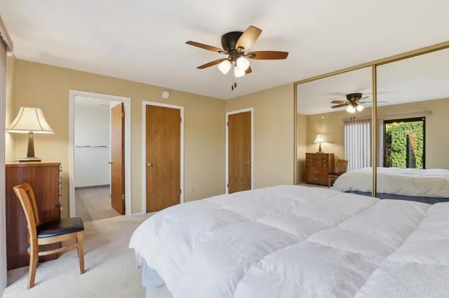 a bedroom with a bed and a chair