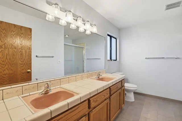 a bathroom with a sink a toilet and a mirror