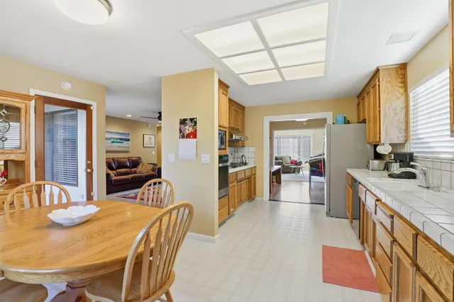 a view of a dining room with furniture and a chandelier