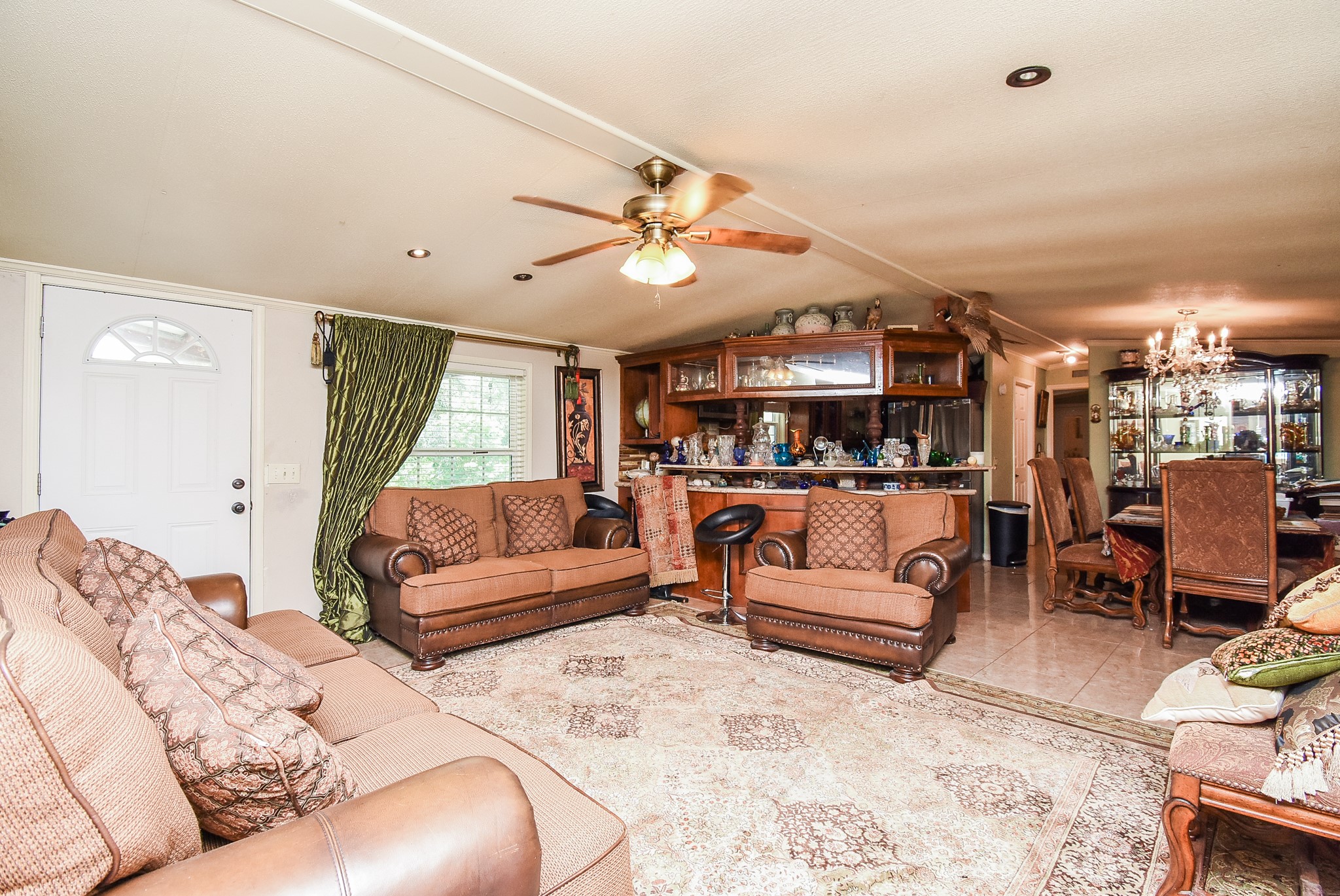 39551 Donigan Road Brookshire, TX 77423 - Photo 19 of 37 Tiled living area with a ceiling fan, hanging lights, and vaulted ceiling