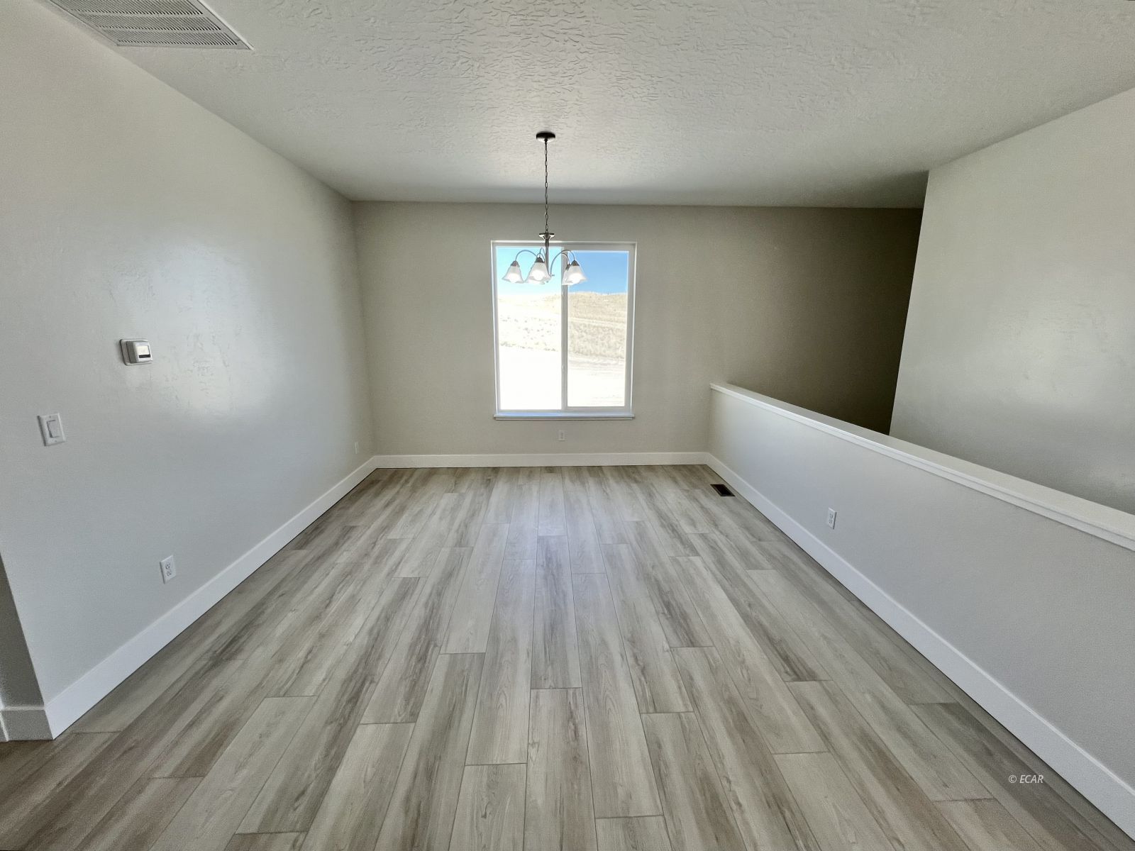 518 Ridgeway Drive Spring Creek, NV 89815 - Photo 8 of 37 wooden floor in an empty room with a window