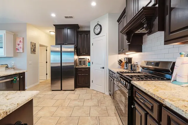 a bathroom with a granite countertop bathtub sink vanity and mirror