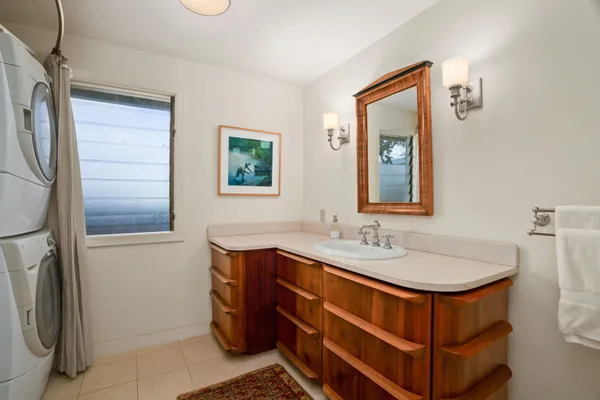 a bathroom with a sink toilet and mirror