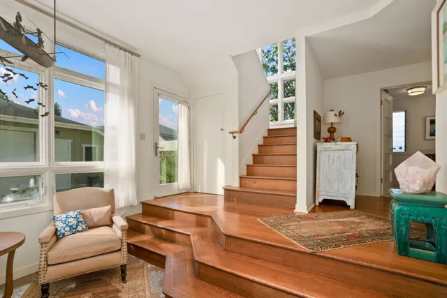 a view of a house with backyard and sitting area
