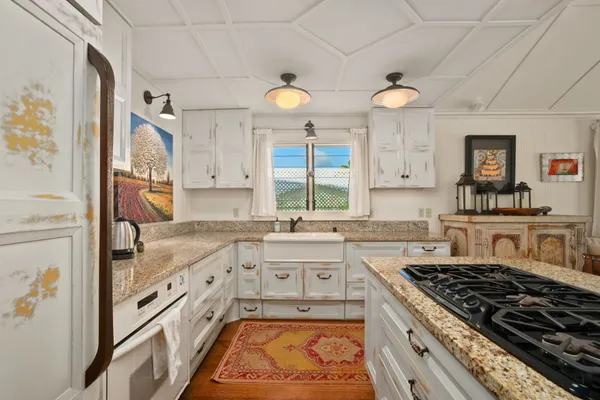 a large kitchen with stainless steel appliances granite countertop a stove and a sink