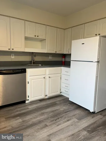a white refrigerator freezer sitting inside of a kitchen