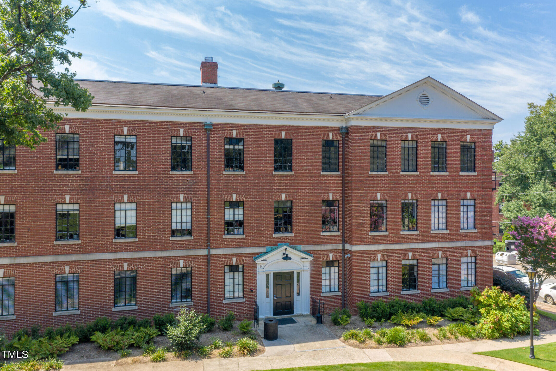 a front view of a building with a yard