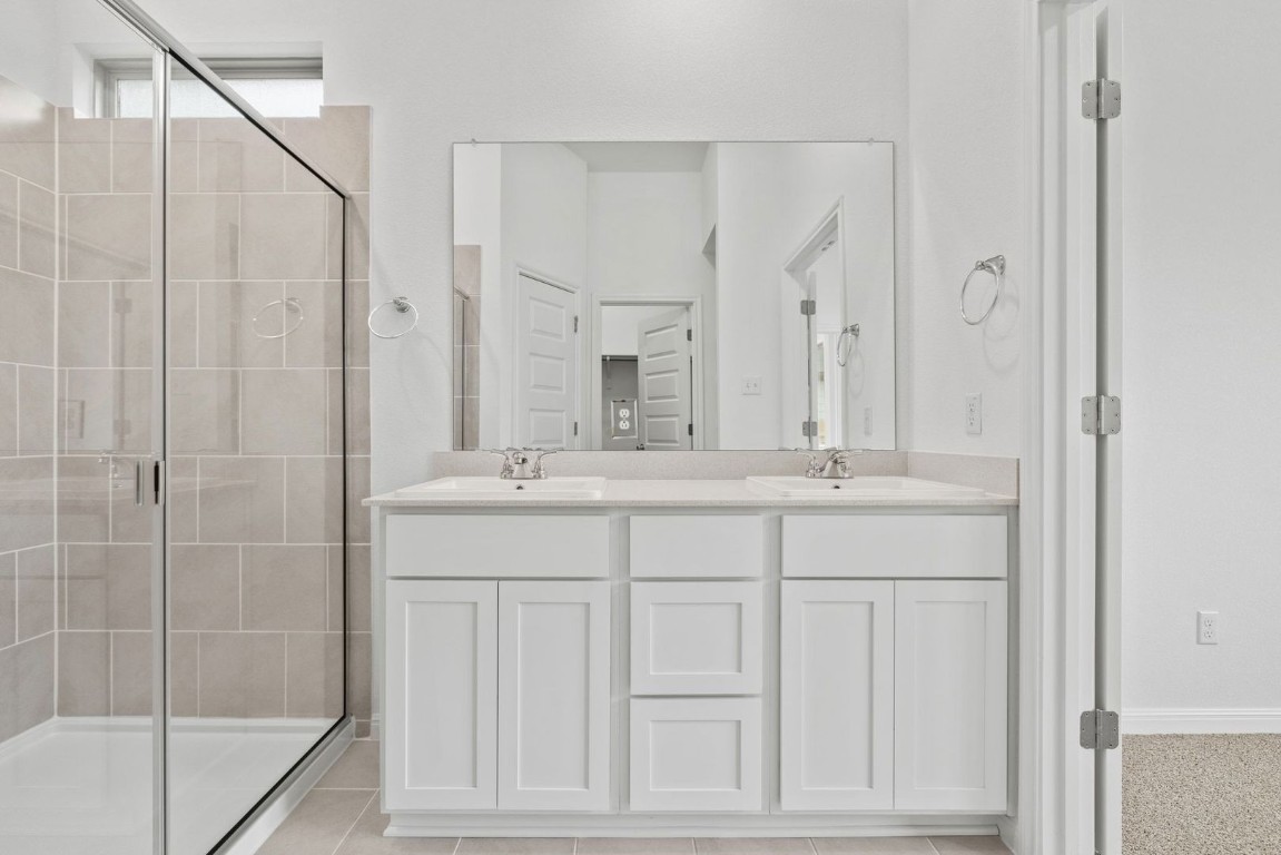 1249 Minorca Street Huffman, TX 77336 - Photo 14 of 25 a bathroom with a double vanity sink and a mirror