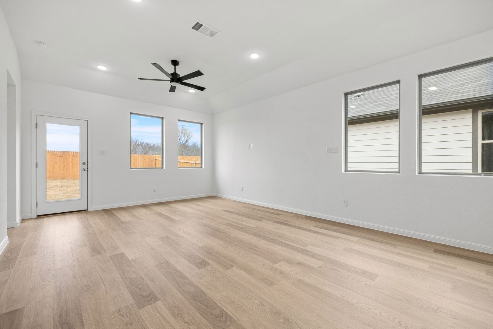 1249 Minorca Street Huffman, TX 77336 - Photo 3 of 25 wooden floor in an empty room with a window