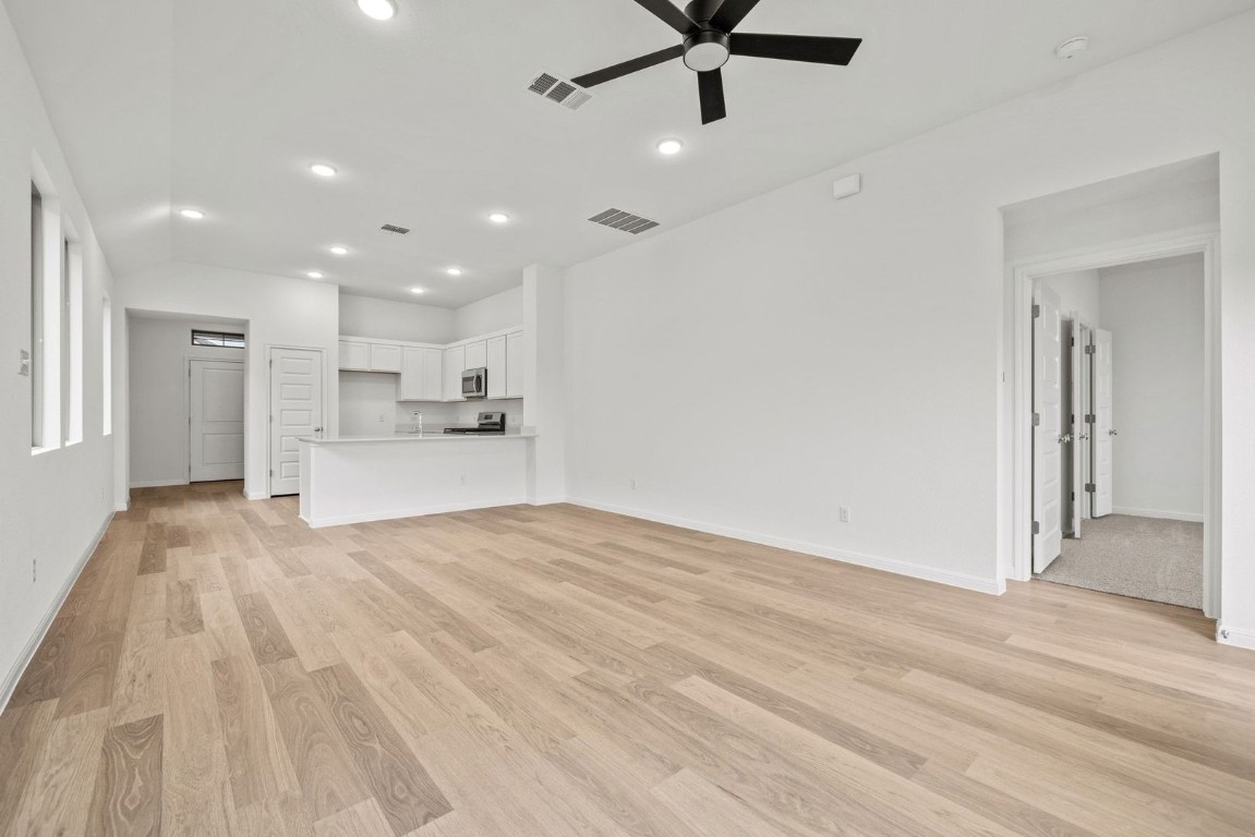 1249 Minorca Street Huffman, TX 77336 - Photo 4 of 25 a view of a kitchen with a sink and dishwasher a refrigerator with wooden floor