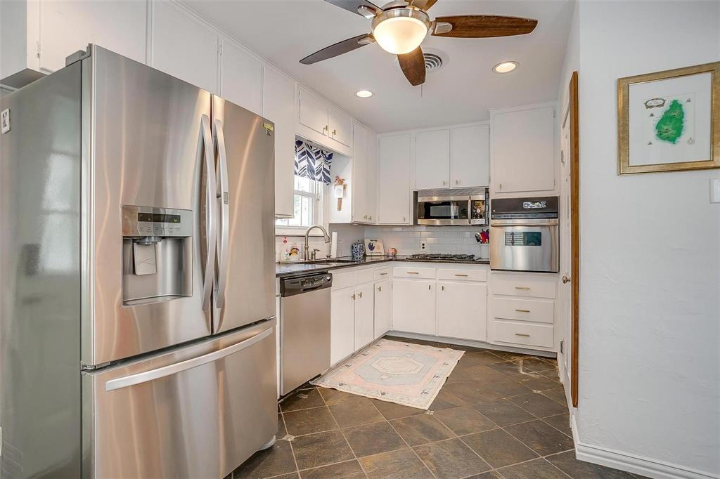 3616 Hilltop Road Fort Worth, TX 76109 - Photo 13 of 39 a kitchen with stainless steel appliances granite countertop a refrigerator and a stove top oven