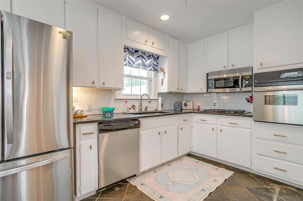 3616 Hilltop Road Fort Worth, TX 76109 - Photo 17 of 39 a kitchen with cabinets appliances a sink and a window