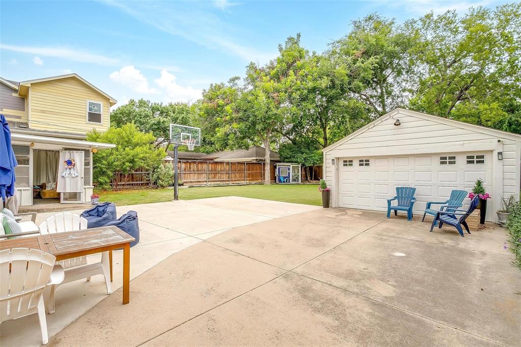 3616 Hilltop Road Fort Worth, TX 76109 - Photo 34 of 39 a view of a house with a patio and a yard