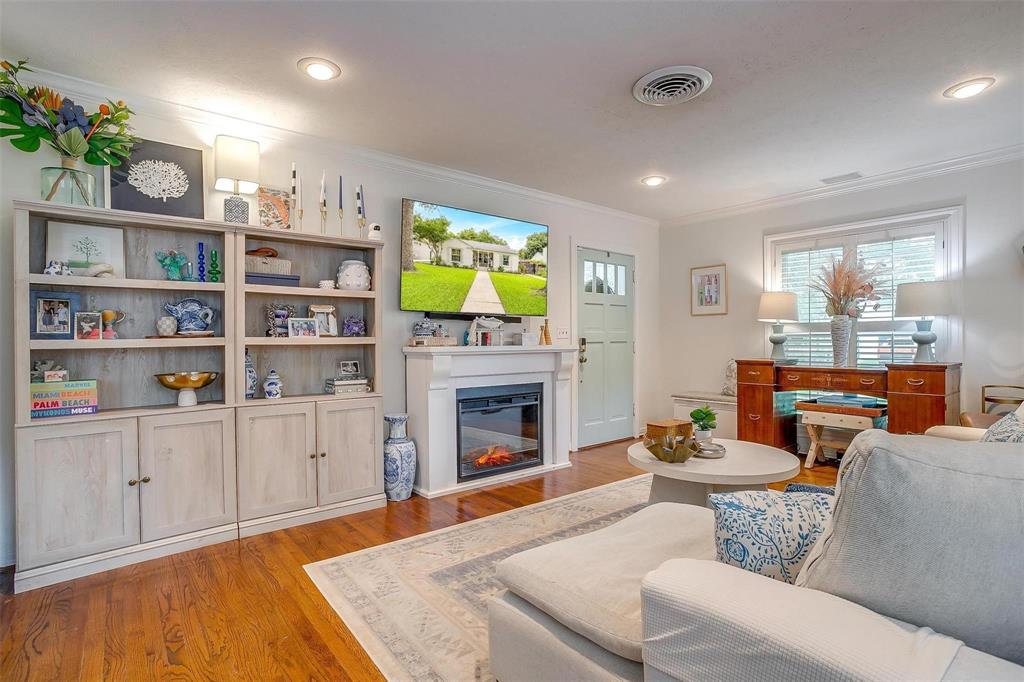 3616 Hilltop Road Fort Worth, TX 76109 - Photo 8 of 39 a living room with furniture a fireplace and a flat screen tv