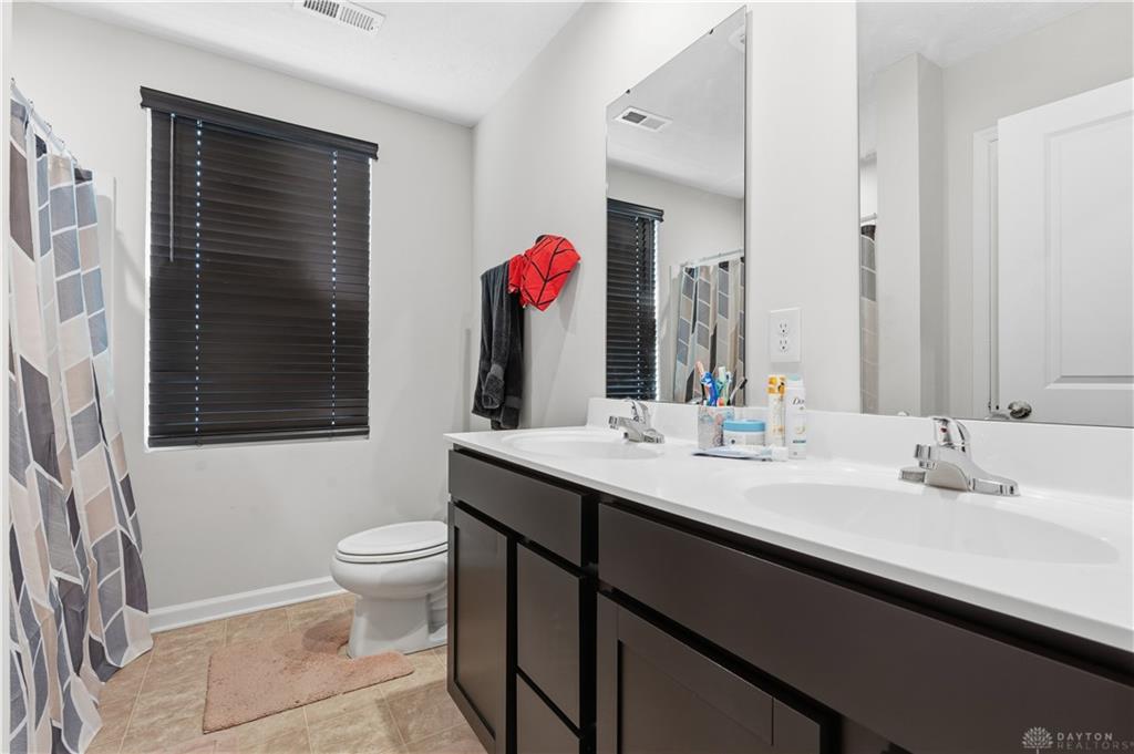 166 Chesapeake Circle Springfield, OH 45505 - Photo 10 of 15 This bright bathroom features a spacious dual vanity and ample natural light, creating a refreshing atmosphere.