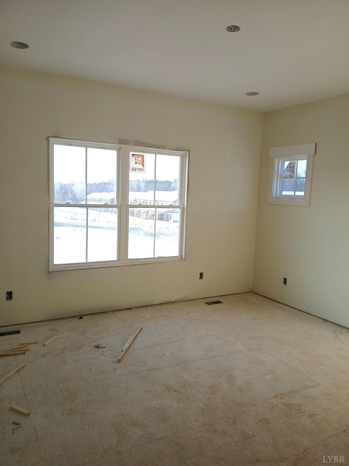 184 Zion Place Rustburg, VA 24588 - Photo 6 of 8 an empty room with a empty space and windows