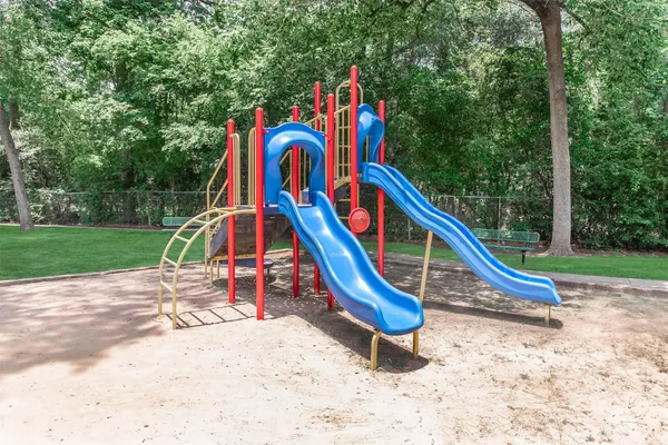a wooden bench sitting in the middle of a park