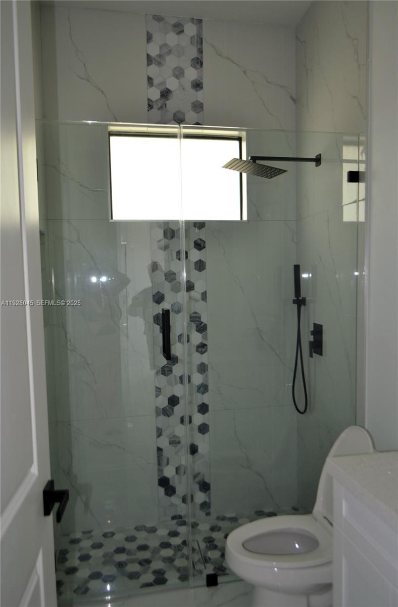 1116 Eight Street Lehigh Acres, FL 33972 - Photo 12 of 20 a bathroom with a toilet and a shower