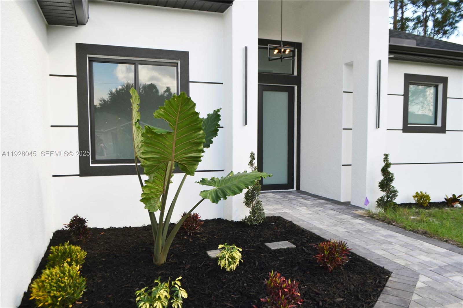 1116 Eight Street Lehigh Acres, FL 33972 - Photo 4 of 20 a vase of flowers sitting on a table in front of a window