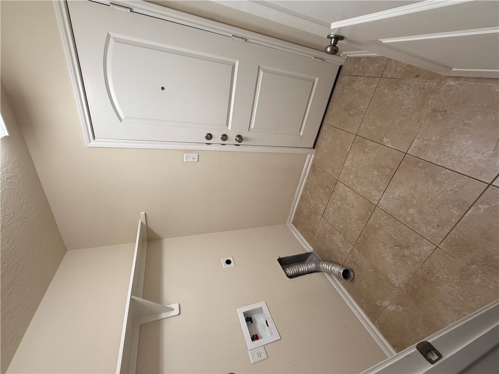 2208 Rindle Court Brenham, TX 77833 - Photo 12 of 22 a view of a closet area with empty racks