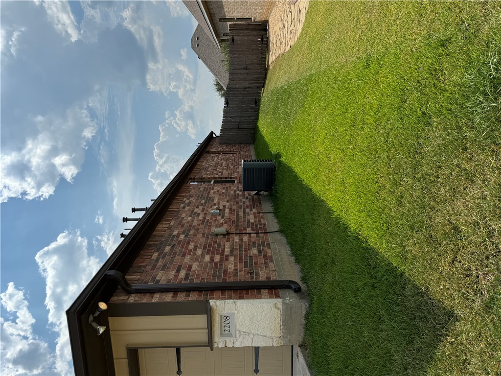 2208 Rindle Court Brenham, TX 77833 - Photo 16 of 22 a view of a backyard with potted plants and large tree