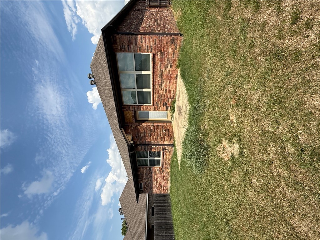 2208 Rindle Court Brenham, TX 77833 - Photo 17 of 22 a front view of a house with a yard
