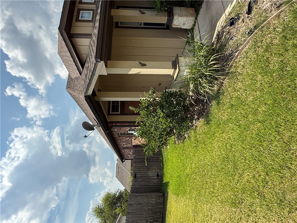 2208 Rindle Court Brenham, TX 77833 - Photo 19 of 22 a front view of a house with garden