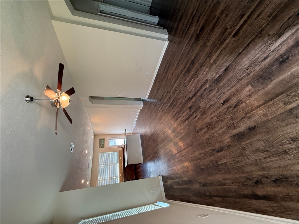 2208 Rindle Court Brenham, TX 77833 - Photo 3 of 22 wooden floor in an empty room with a window