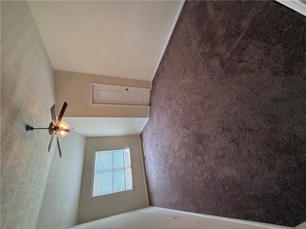 2208 Rindle Court Brenham, TX 77833 - Photo 5 of 22 en empty room with windows and ceiling fan