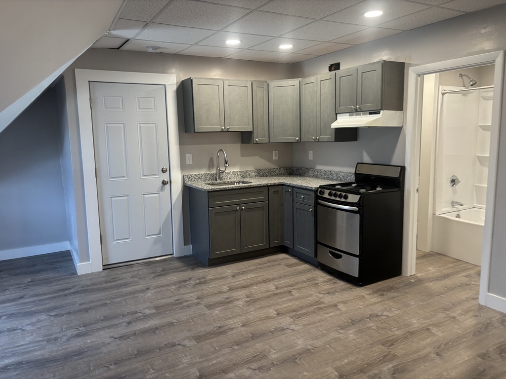 771 Rock Street Fall River, MA 02720 - Photo 16 of 31 a kitchen with stainless steel appliances granite countertop a stove a sink and a refrigerator