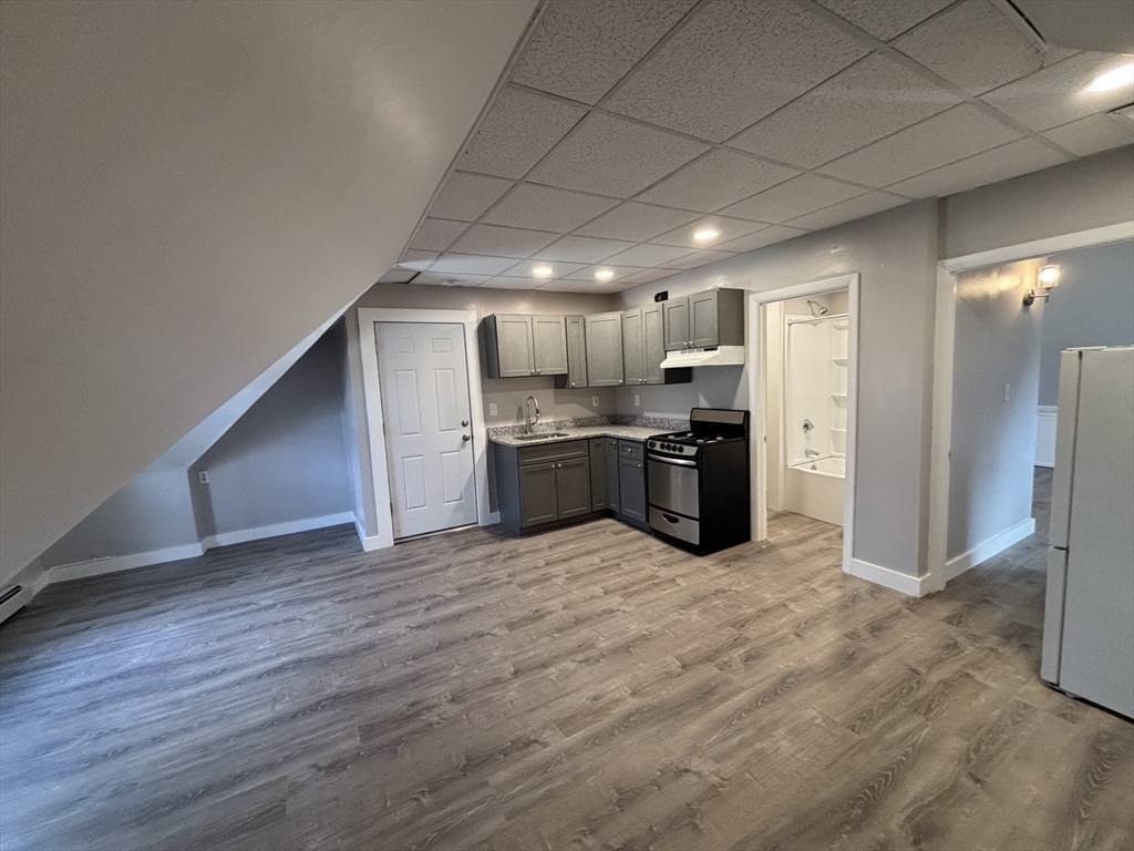 771 Rock Street Fall River, MA 02720 - Photo 17 of 31 a view of a electric appliances in kitchen and empty room with wooden floor