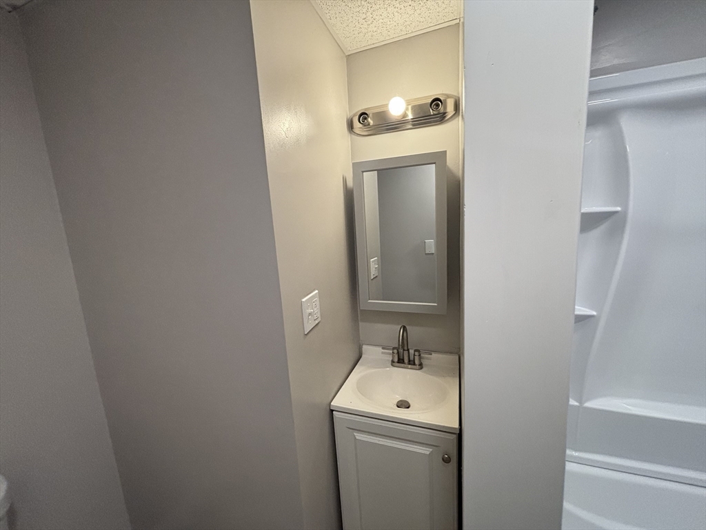 771 Rock Street Fall River, MA 02720 - Photo 19 of 31 a bathroom with a toilet sink and mirror