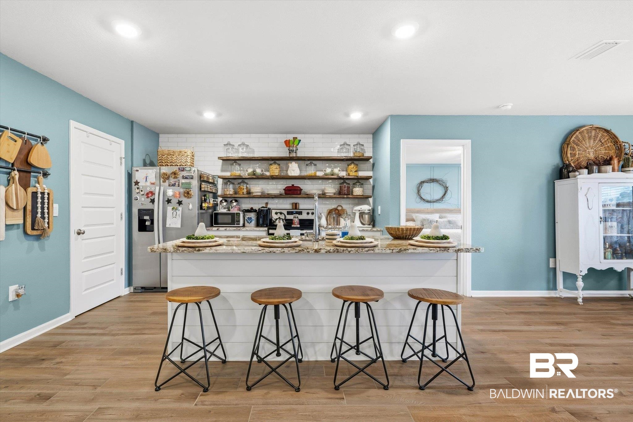 17041 Muse Street Loxley, AL 36551 - Photo 5 of 44 Kitchen featuring open shelves, light wood finished floors, light stone countertops, a kitchen bar, and recessed lighting