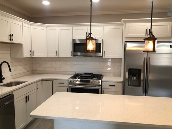131 Congress Avenue, Unit 2 Chelsea, MA 02150 - Photo 11 of 30 a kitchen with a sink a stove and refrigerator