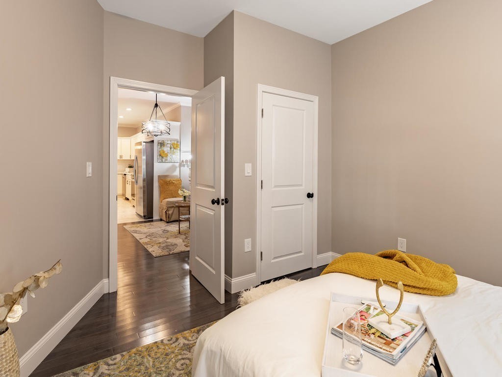 131 Congress Avenue, Unit 2 Chelsea, MA 02150 - Photo 16 of 30 a bedroom with a bed and wooden floor