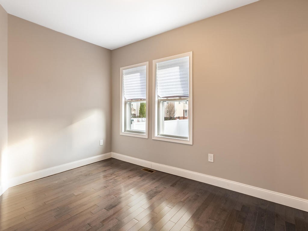 131 Congress Avenue, Unit 2 Chelsea, MA 02150 - Photo 19 of 30 an empty room with wooden floor and windows