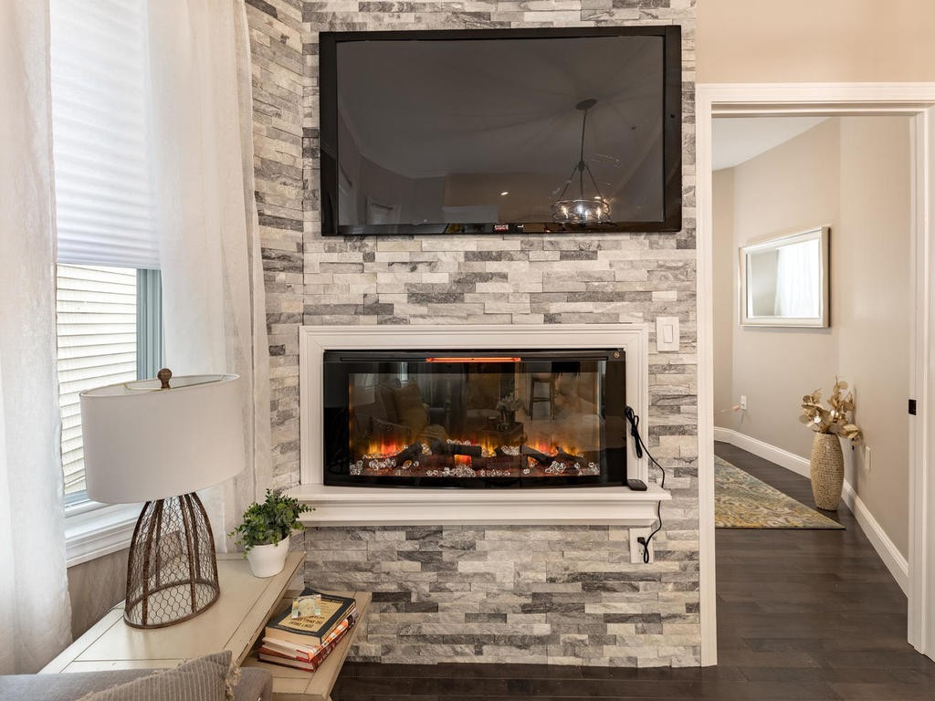 131 Congress Avenue, Unit 2 Chelsea, MA 02150 - Photo 6 of 30 a living room with furniture a fireplace and a flat screen tv