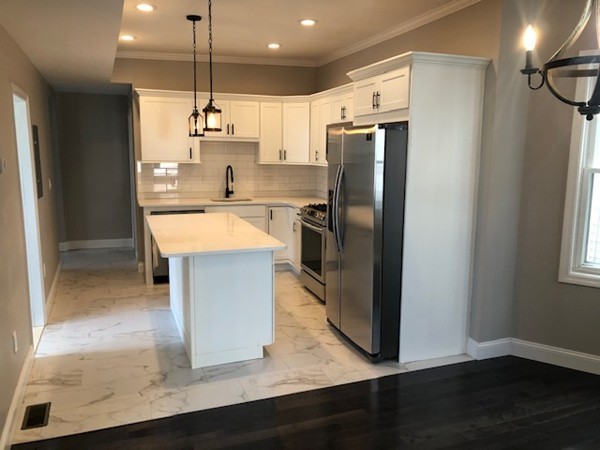 131 Congress Avenue, Unit 2 Chelsea, MA 02150 - Photo 7 of 30 a kitchen with stainless steel appliances granite countertop a refrigerator a sink dishwasher a stove and a refrigerator with wooden floor
