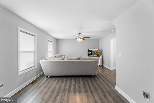 a view of room with window and wooden floor
