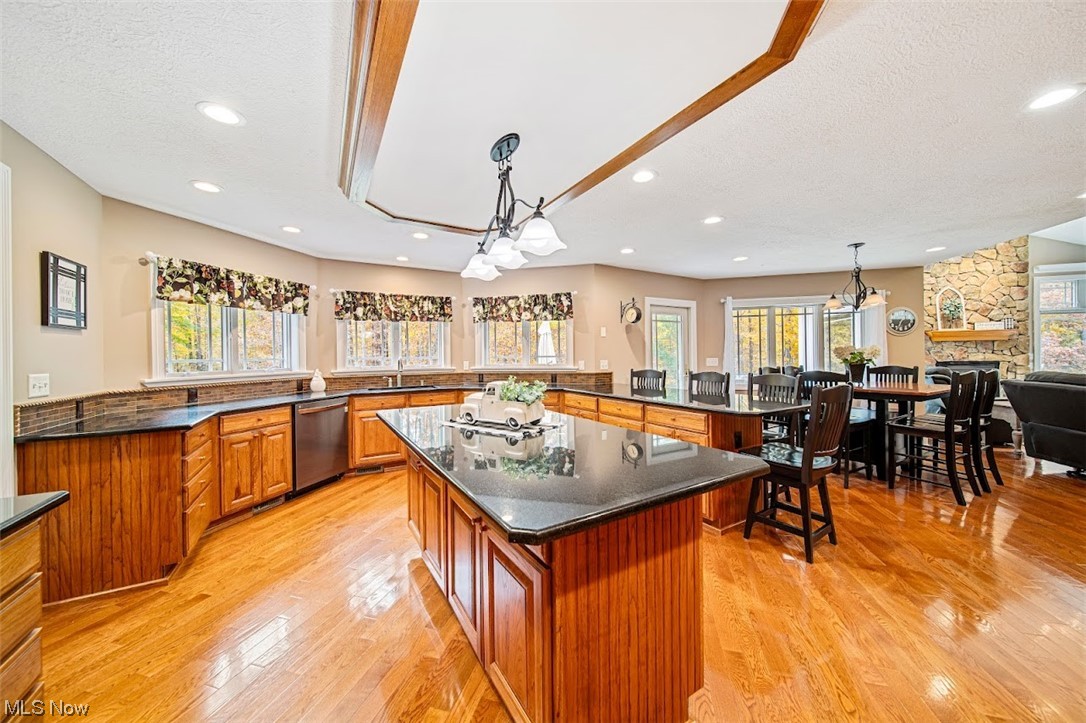 12151 Girdled Road Painesville, OH 44077 - Photo 12 of 35 Kitchen featuring light hardwood / wood-style floors, a center island, and a chandelier