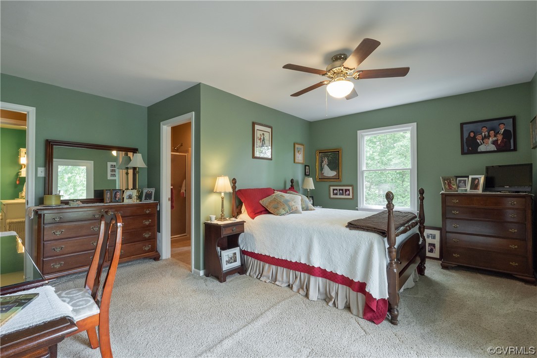 213 Greenvale Creek Road Lancaster, VA 22503 - Photo 23 of 50 a bedroom with a bed and a chandelier