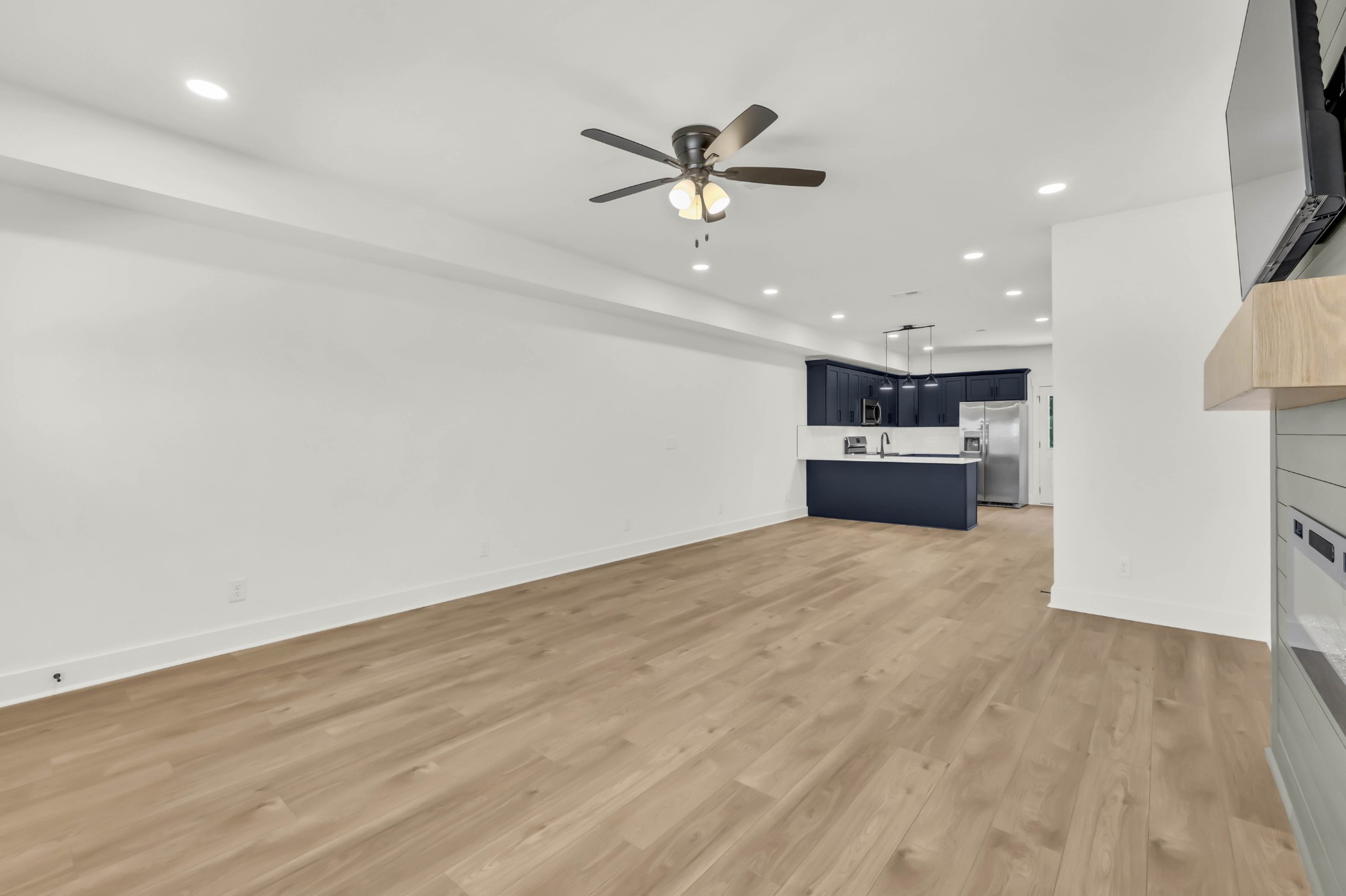 352 Front Rdg Circle Clarksville, TN 37042 - Photo 9 of 29 wooden floor in an empty room with a ceiling fan
